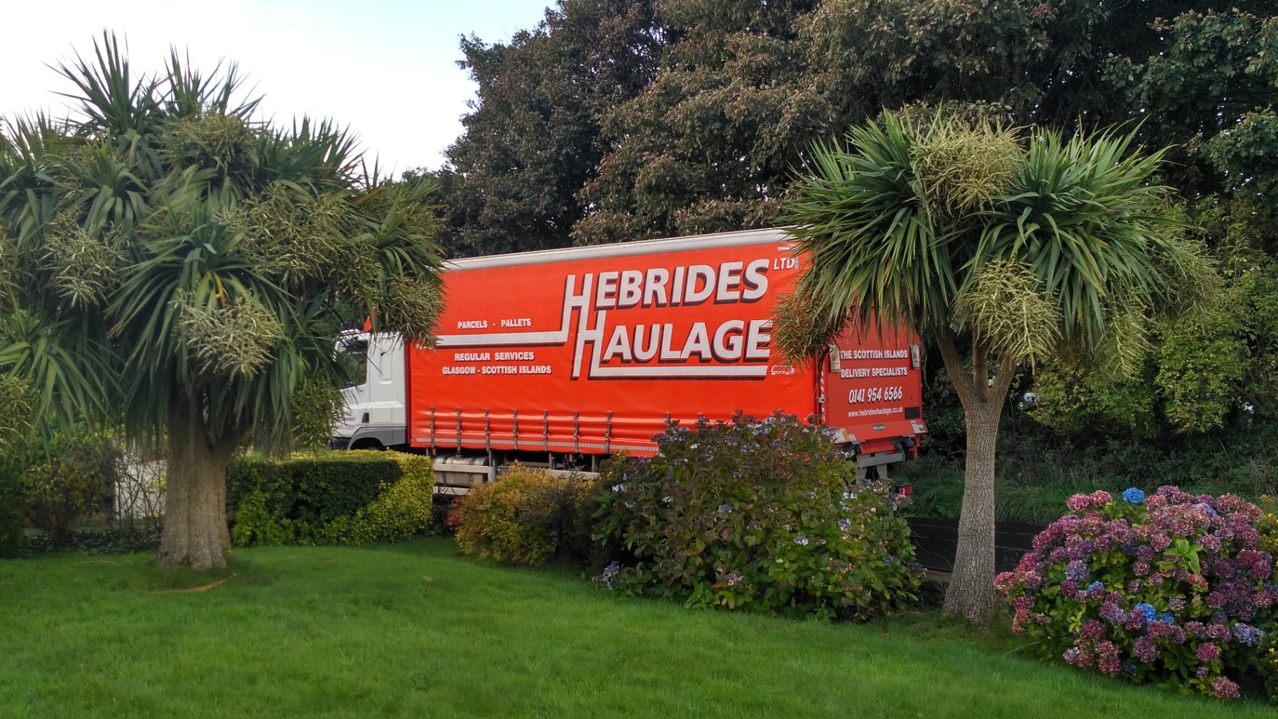 Hebrides Haulage curtain-sider trailer among palm trees