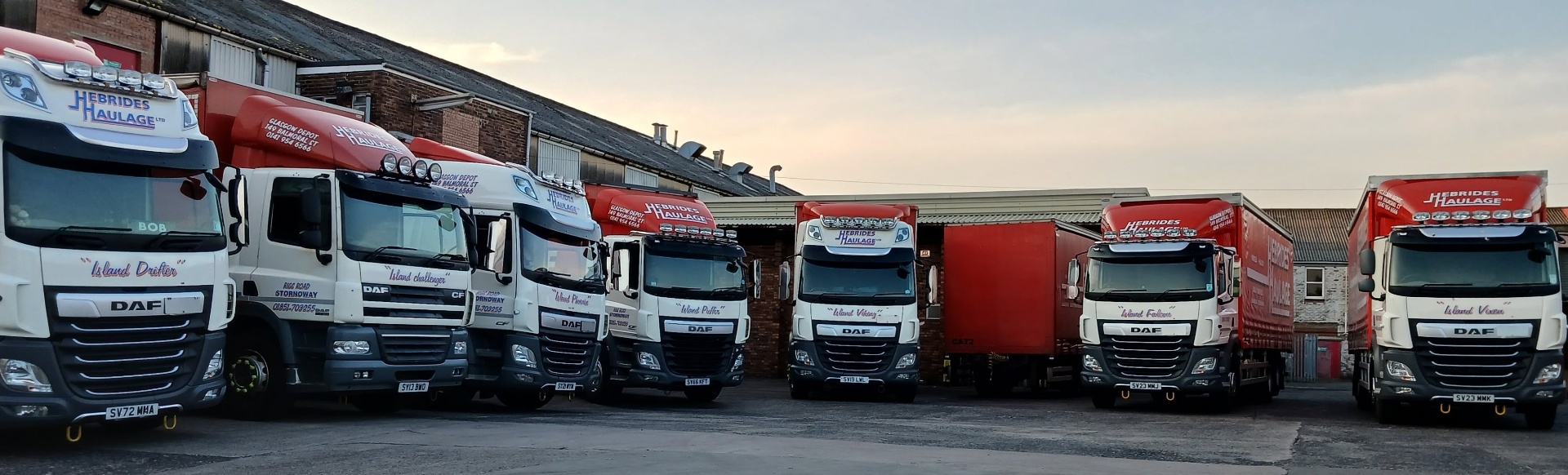 Hebrides Haulage DAF fleet lined up outside the Glasgow depot at sunset